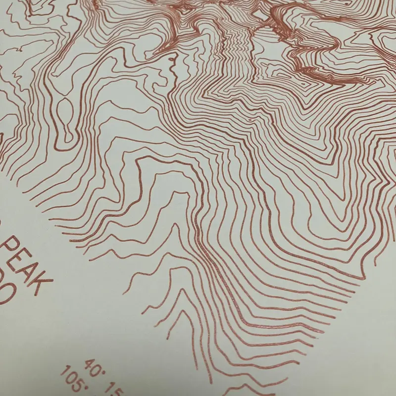 Framed pen-plotted topographic map in the cream colorway displayed in a real room, from the same series as this topographic map of Borah Peak, Idaho
