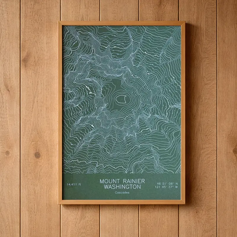Framed pen-plotted topographic map in the green colorway displayed in a real room, from the same series as this topographic map of Borah Peak, Idaho